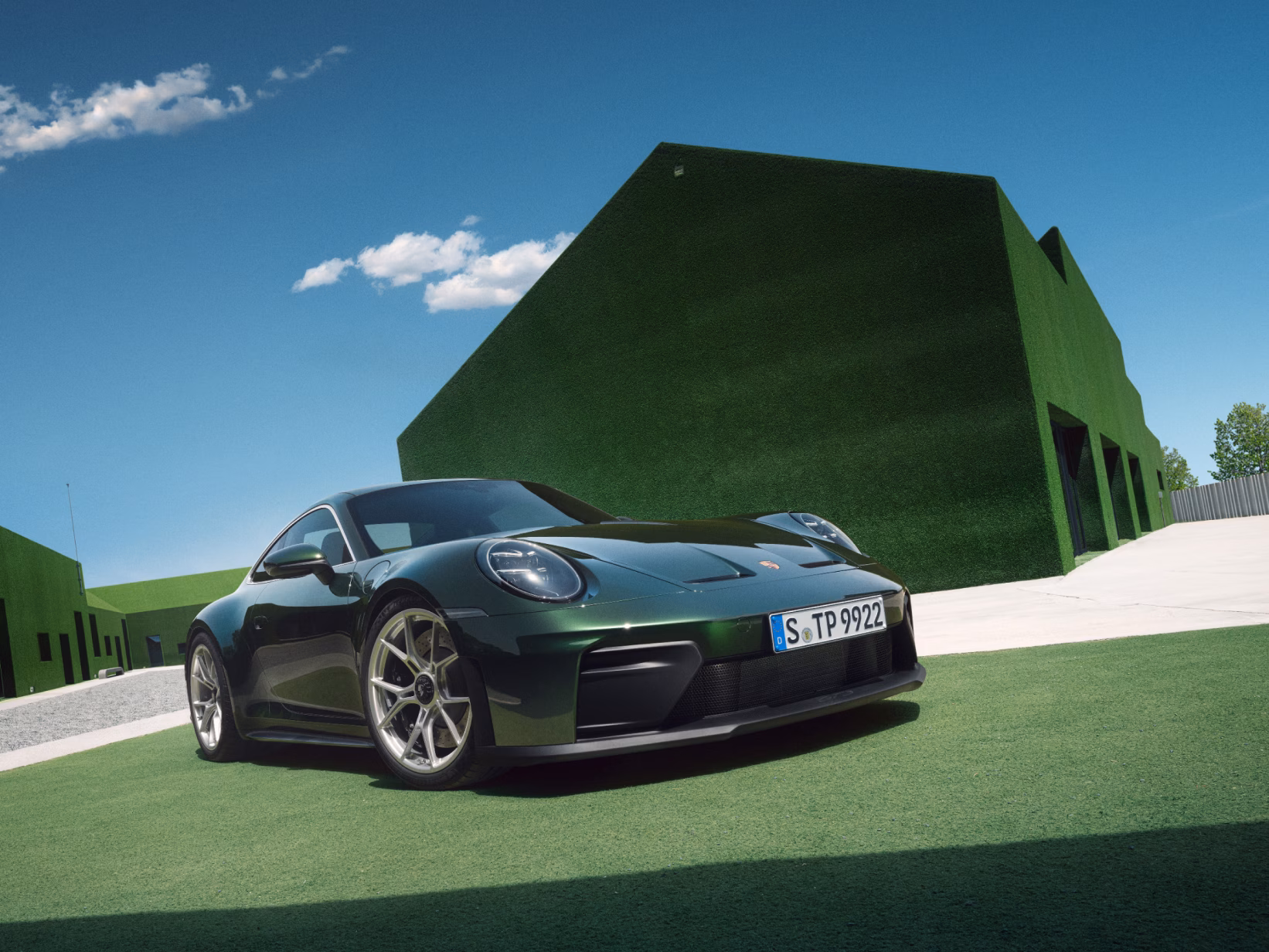 View of the front and side of the Porsche 911 GT3 with Touring package in Oak Green Metallic Neo.