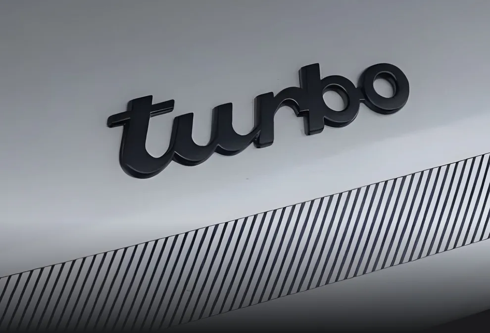 Detailed view of the "Turbo" lettering  on the rear of a Porsche 911 Turbo. 