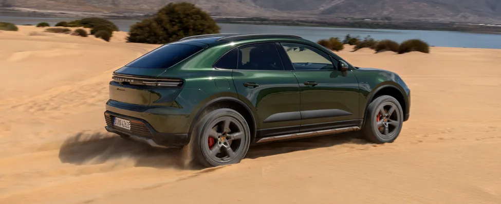 Porsche Macan 4S in Oak Green Metallic driving over terrain.