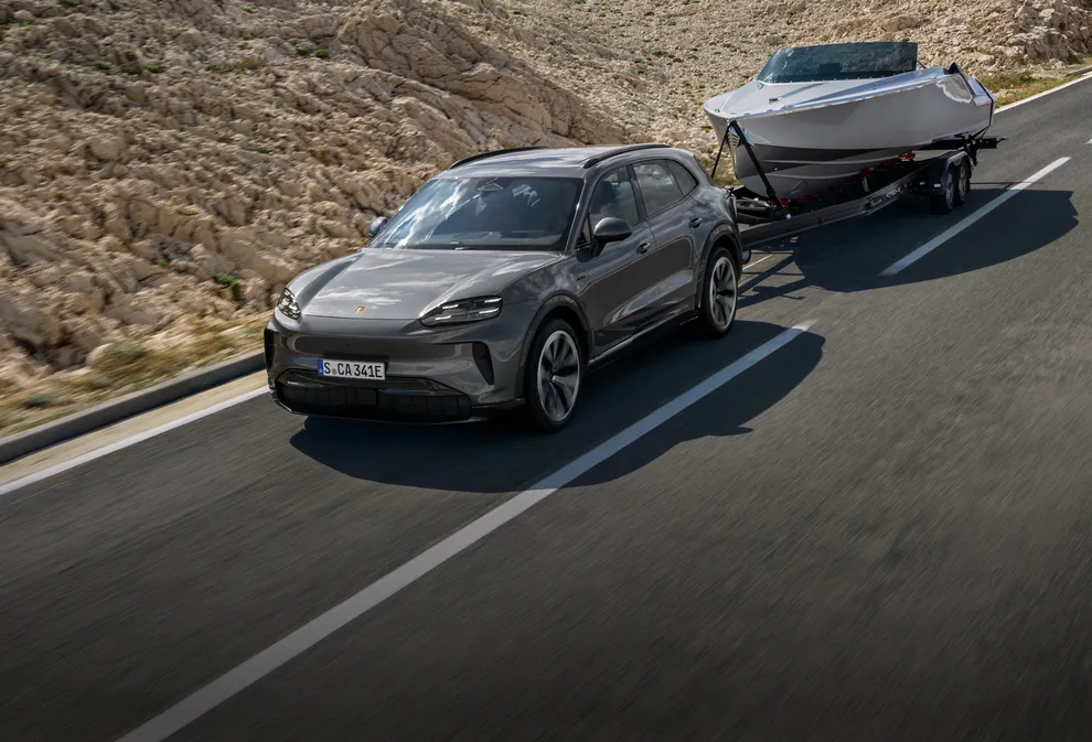 A Porsche Cayenne Turbo in Mystic Green Metallic being used for transport.