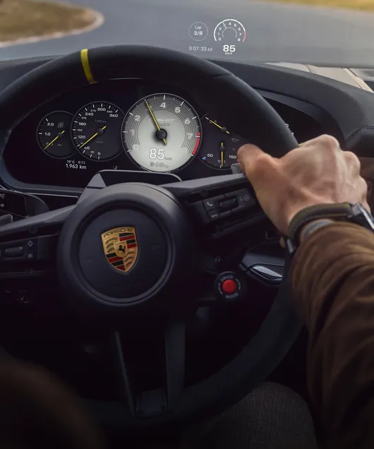 Porsche Cayenne Turbo GT interior: detailed view of the head-up display while driving on a circuit.