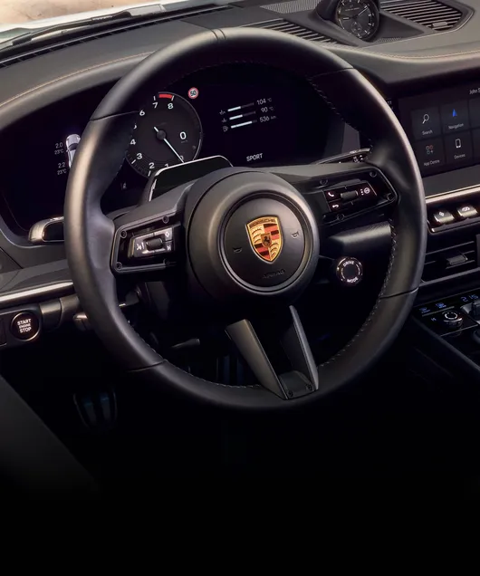Detailed view of the GT sports steering wheel in the cockpit of the Porsche 911 Carrera T Cabriolet.