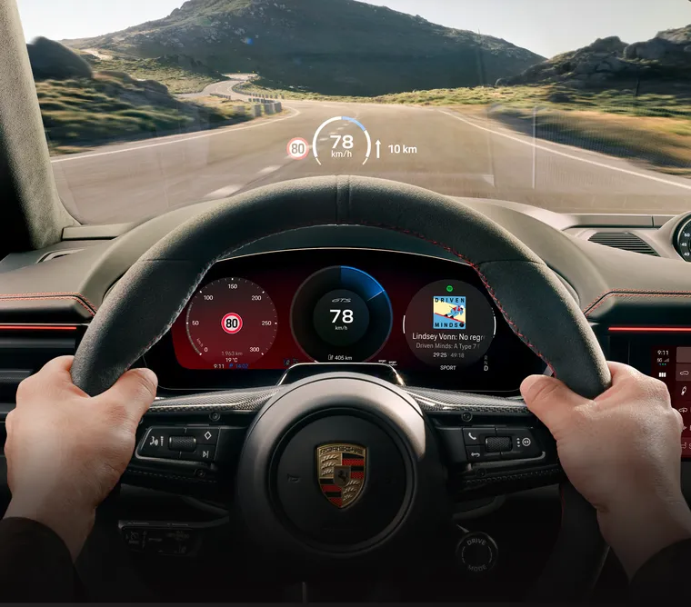 View from the driver's perspective of the AR Head-Up Display in the Porsche Macan GTS Electric while driving.