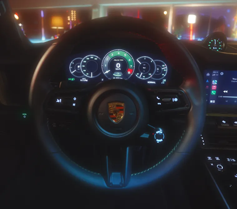 Detailed view of the steering wheel and the illuminated instrument cluster in the Porsche 911 Spirit 70.