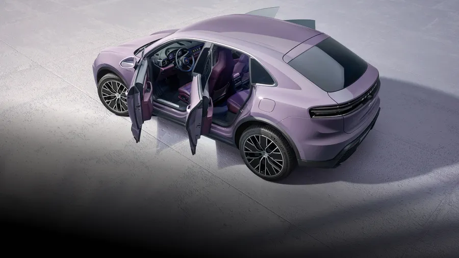 Porsche Macan 4 in Provence, interior with leather package in Black/Bramble, with passenger door open.