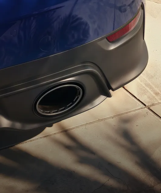 Porsche 911 Carrera S with MT-Package. Rear view. Focus on the tailpipe.