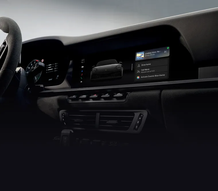 View of the steering wheel and the instrument cluster or curved display in the Porsche 911.