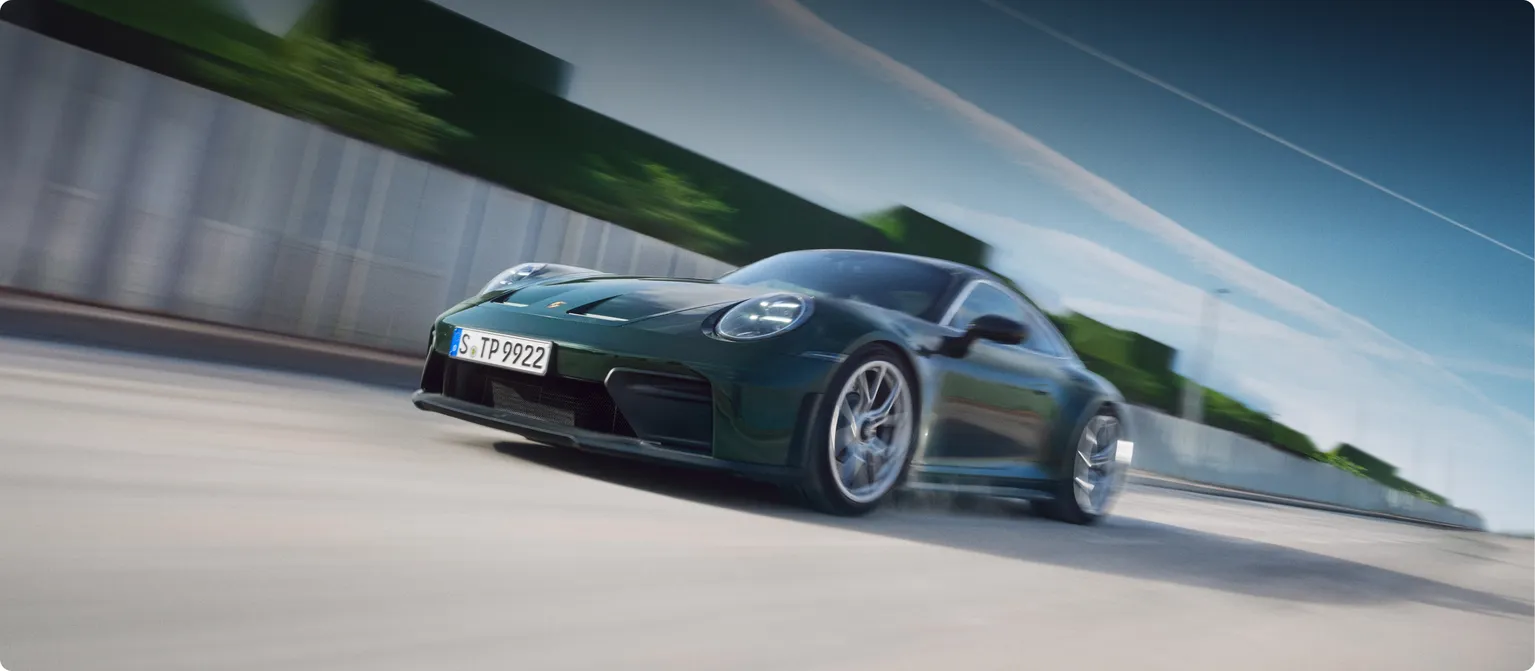 Front view of the front and side of the Porsche 911 GT3 with Touring package in Oak Green Metallic Neo.