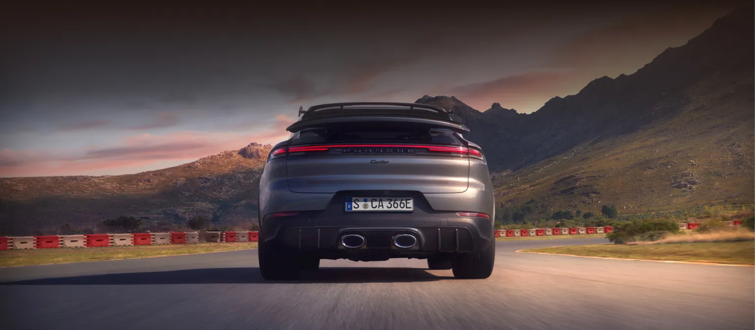 Porsche Cayenne Turbo E-Hybrid Coupé with GT package in Quarzite Grey Metallic. View of rear end from behind.
