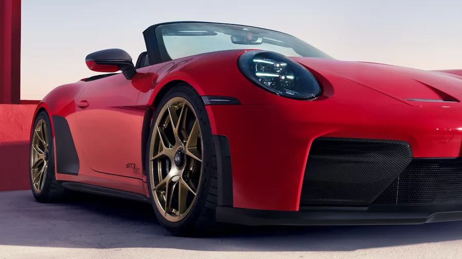 View of the front and side of a Porsche 911 GT3 S/C in Guards Red with Carbon exterior package.