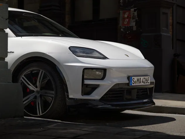 Side view of the front of a Porsche Macan Turbo in Ice Grey Metallic.