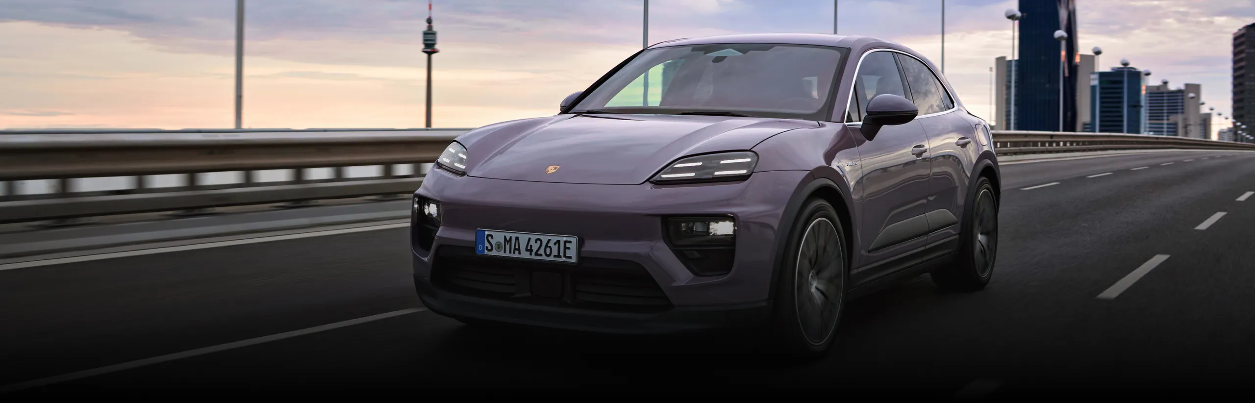 Porsche Macan 4 in Provence driving through the suburbs. Side and front visible.