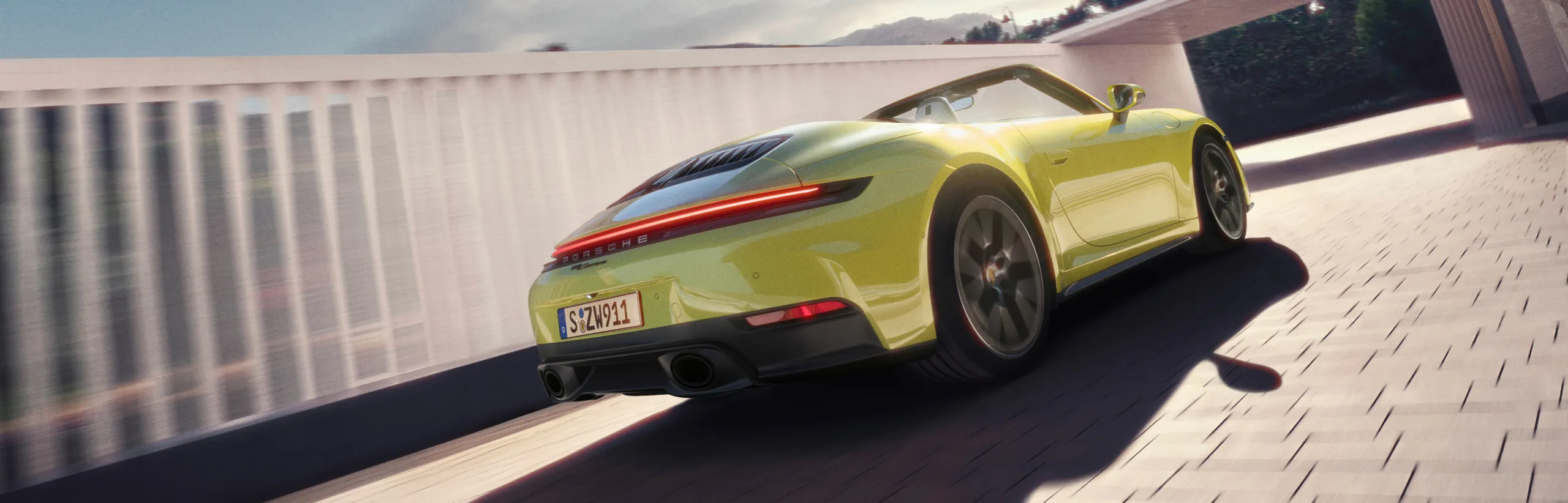 Porsche 911 Carrera GTS Cabriolet цвета черный неметаллик (Black) с красным верхом едет по городу. Вид спереди и сбоку.