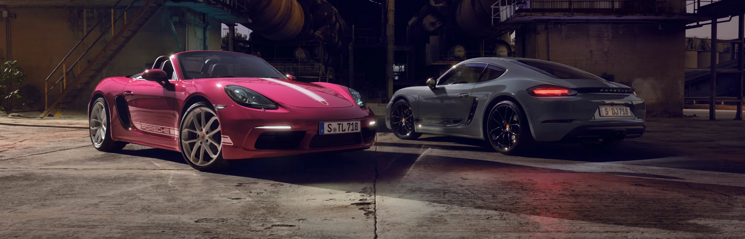 A Porsche 718 Cayman Style Edition in Arctic Grey and a Porsche 718 Boxster Style Edition in Star Ruby Neo driving side by side.