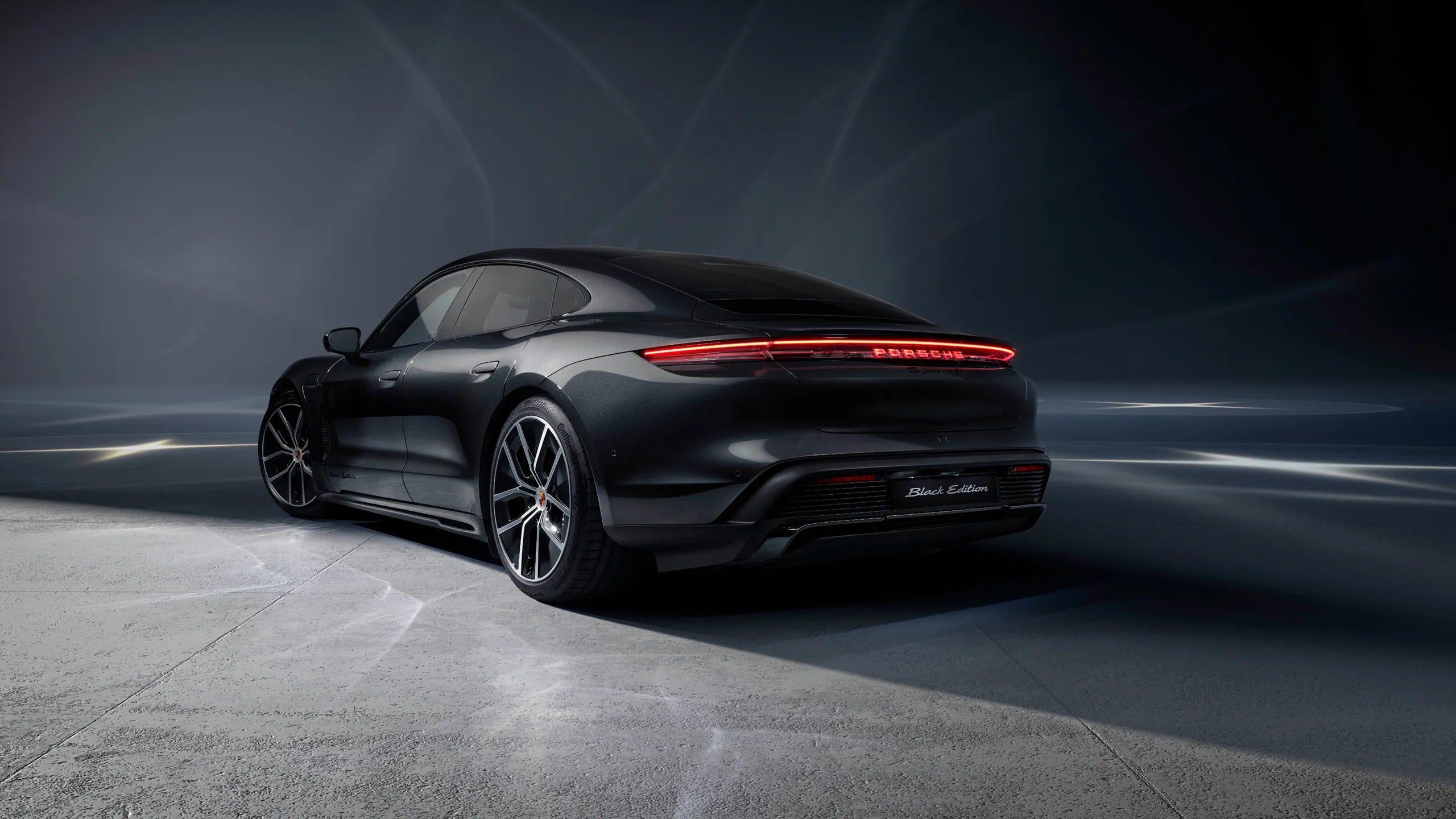 Rear view of a Porsche Taycan 4S Black Edition in Jet Black Metallic.