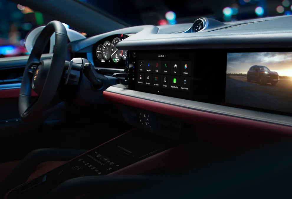 Detailed view of the PCM infotainment system and the passenger display in the Cayenne E-Hybrid Coupé.