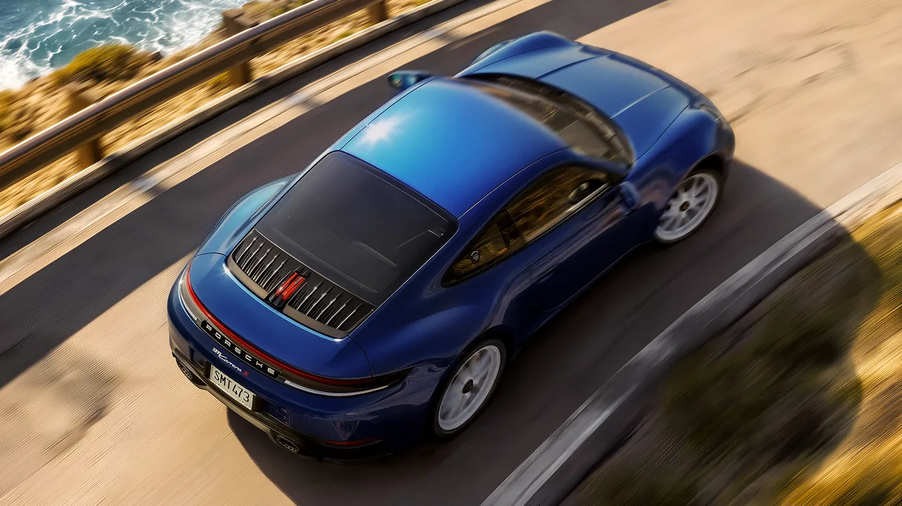 Porsche 911 Carrera S with MT-Package in gentian blue. View of the side and rear from an elevated position.