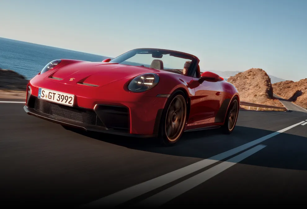 Front view of a Porsche 911 GT3 S/C in Guards Red driving on a country road.