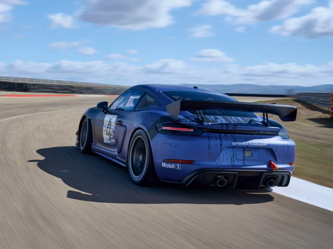 Porsche 718 Cayman GT4 RS Club Sport driving on a race track. View of rear end.