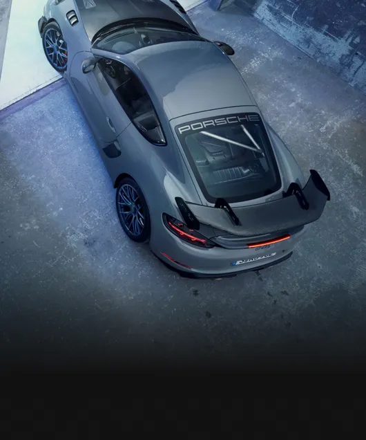 Porsche 718 Cayman GT4 RS in Arctic Grey with Weissach Package in a garage. Bird's-eye view of the roof.