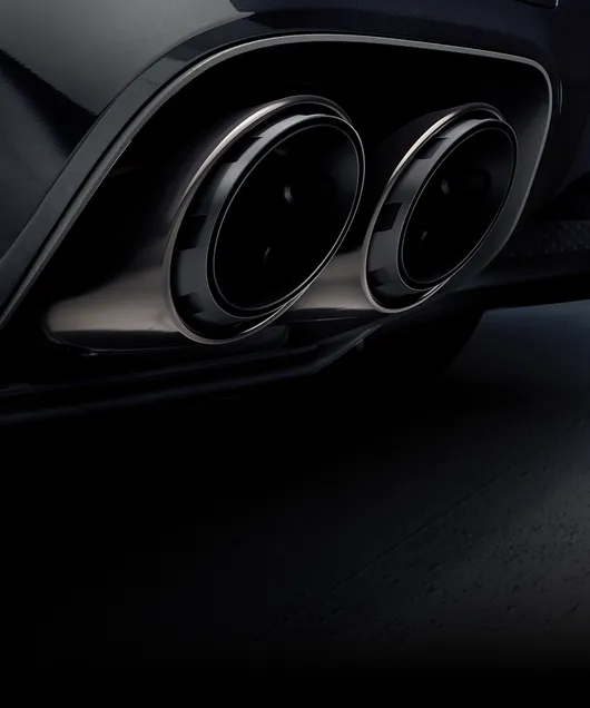 Detailed view of the sports tailpipes in Dark Bronze on the Porsche Cayenne Black Edition.