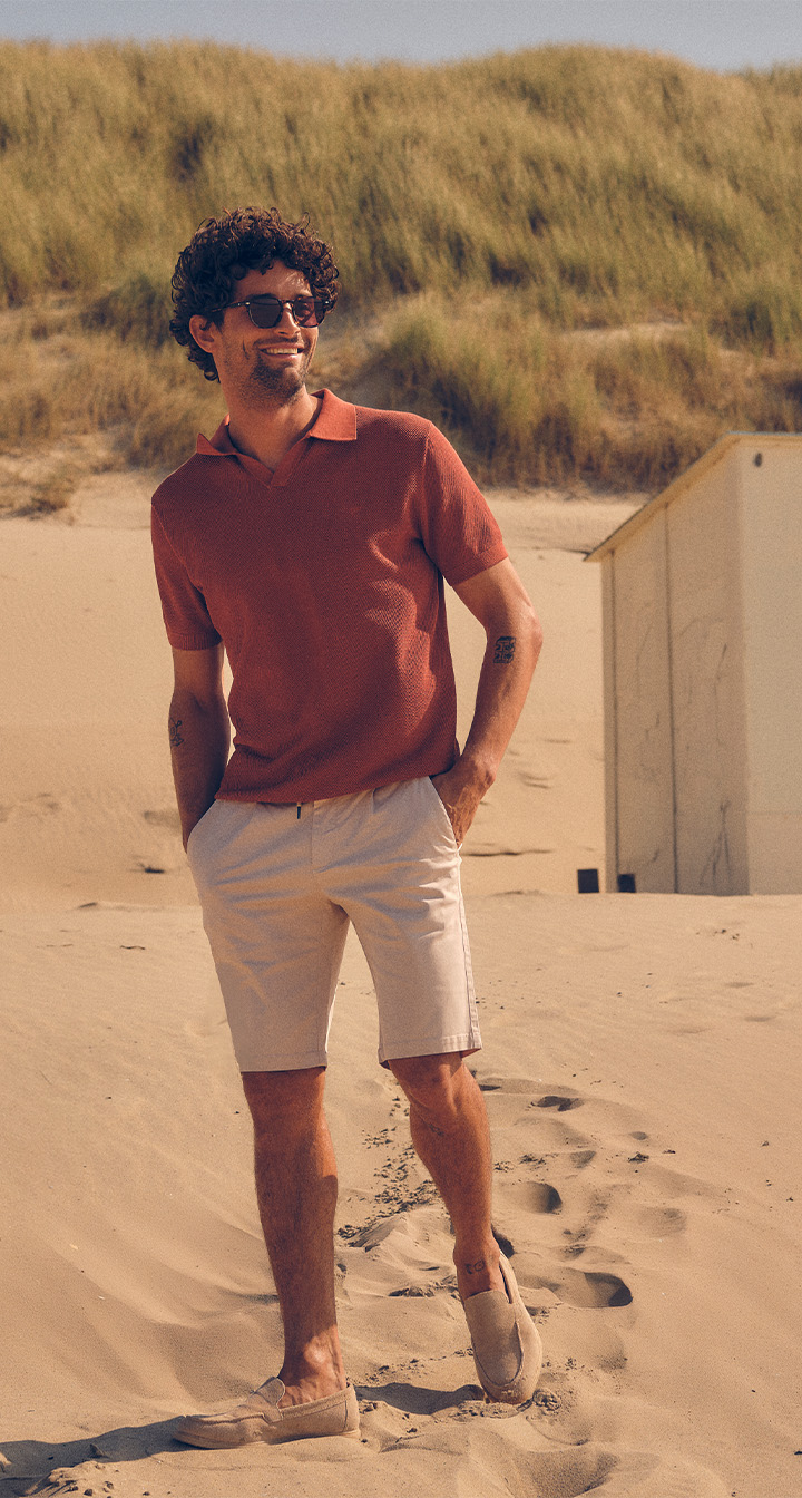 Campbell SS25 outfit, man op het strand met rode polo en shorts
