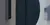 Close-up of a wall-mounted security card reader next to a door, with a blurred background showing part of a building exterior.