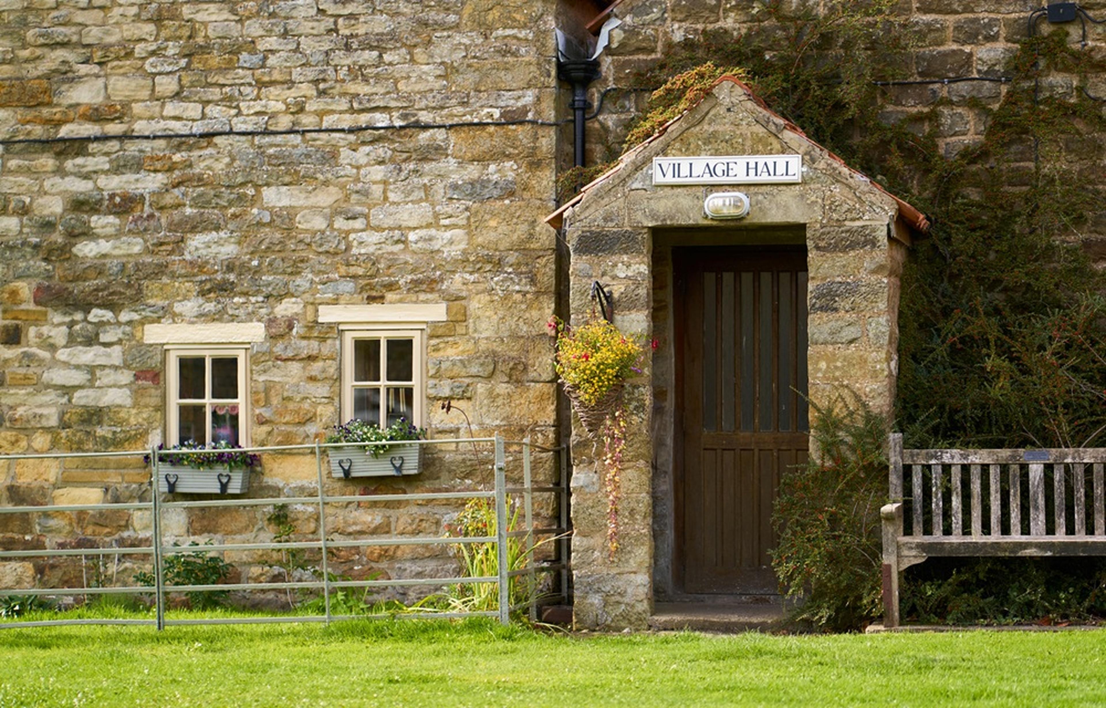 Stone village hall with wooden door