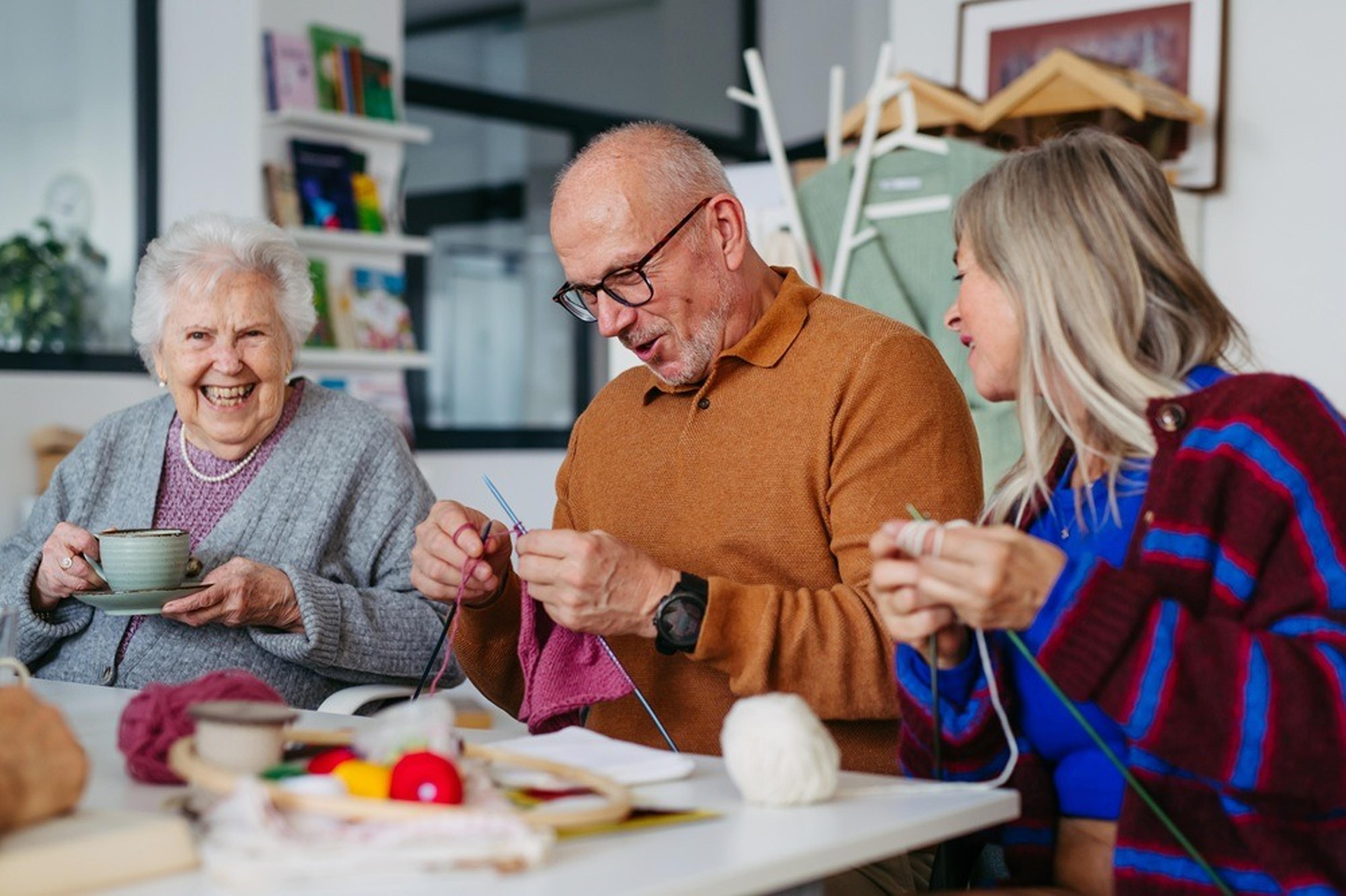 Elderly individuals enjoying a knitting session together
