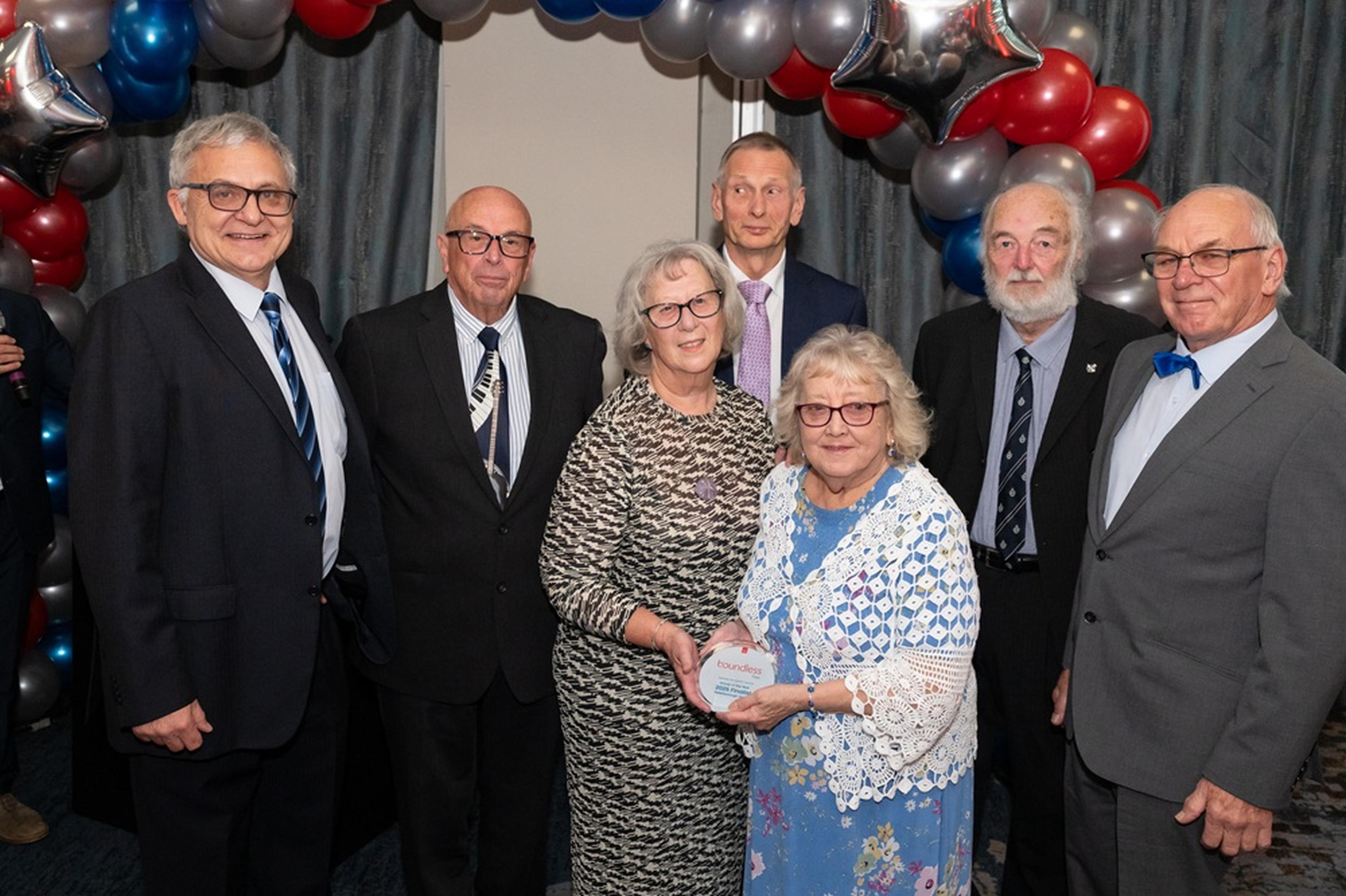 Peterborough Group committee holding award at volunteer recognition event 2025