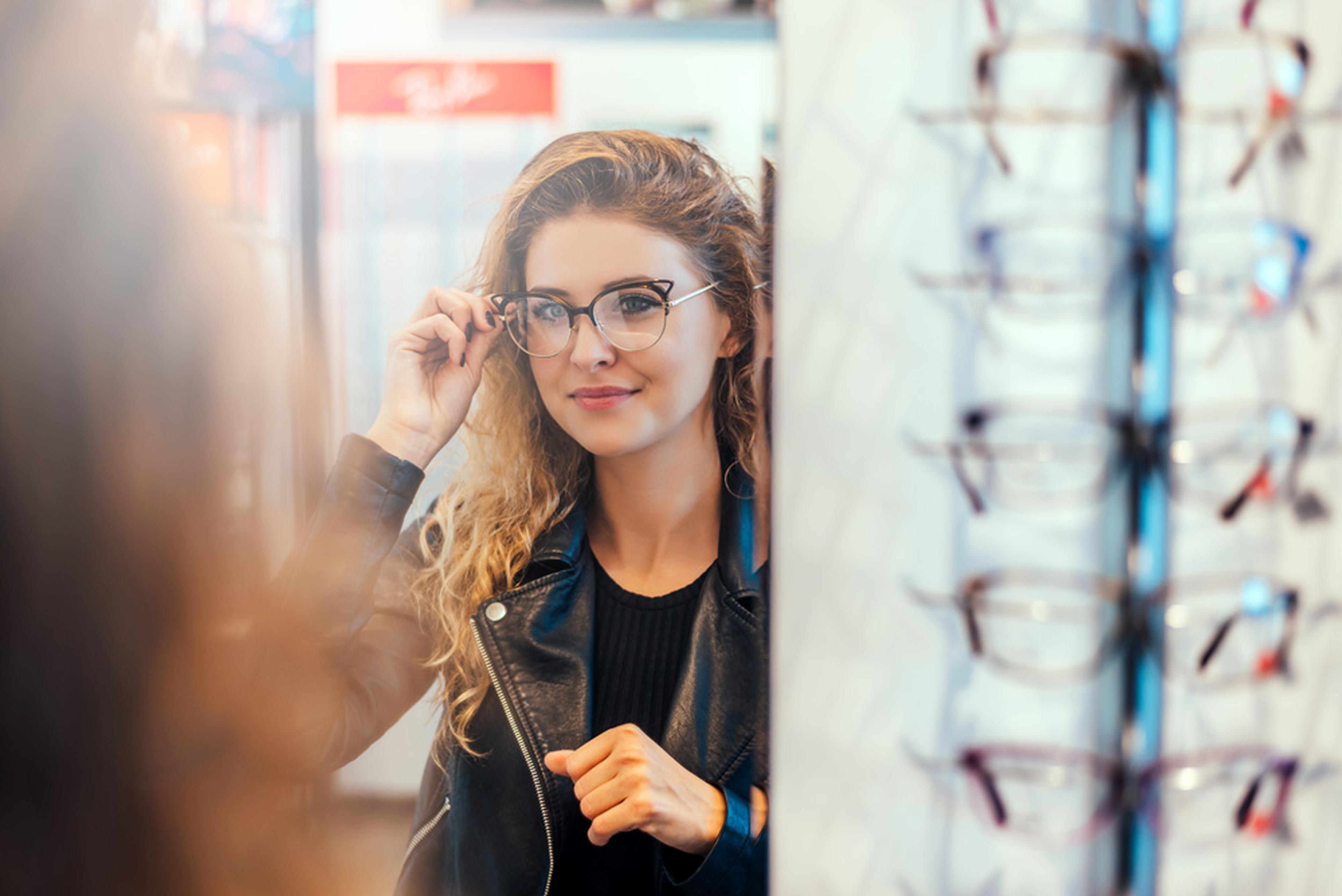 Lady trying on some new glasses in the shop.