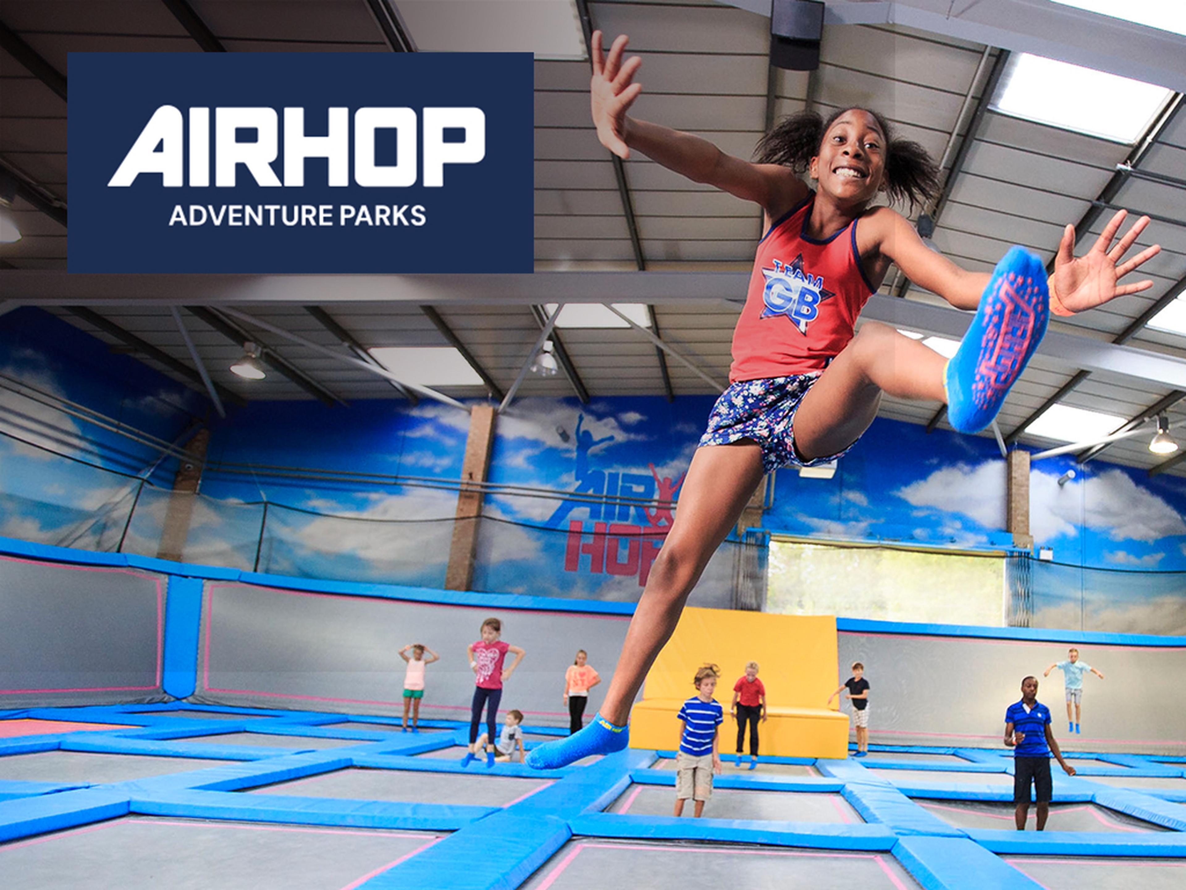 A girl leaps on a trampoline at AirHop trampoline Parks.