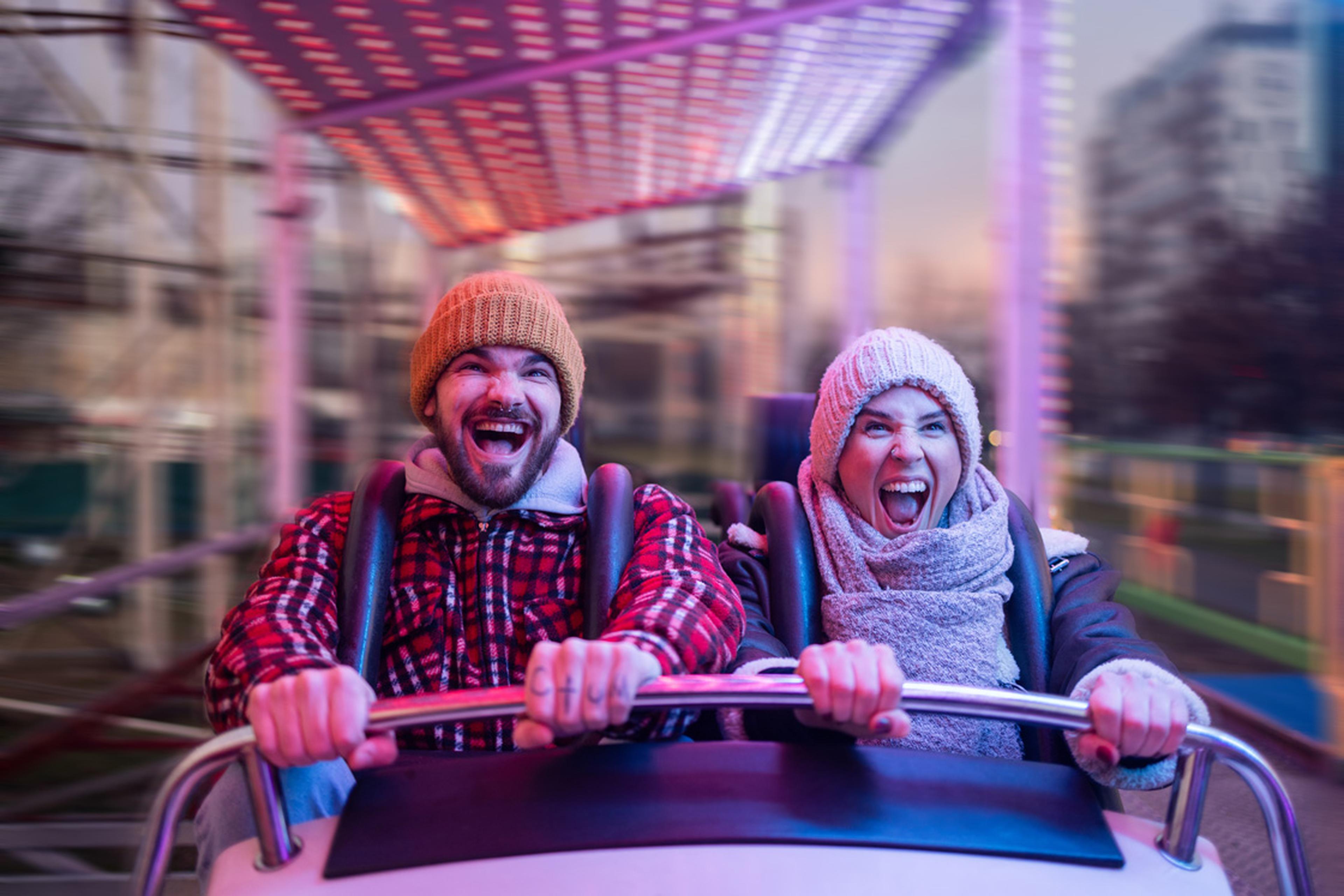 Couple riding on a roller coaster ride.