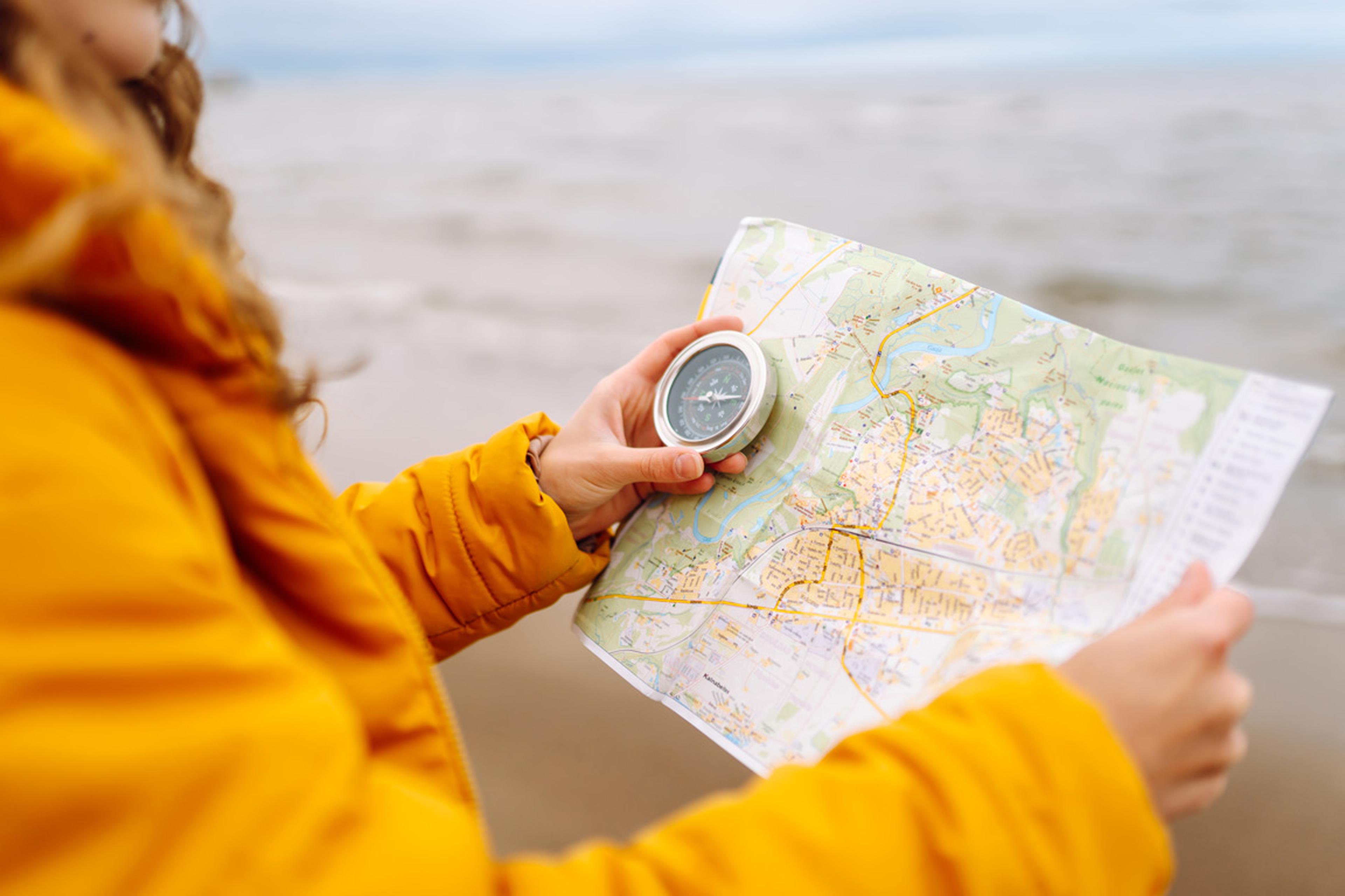 Lady hiking with a map and compass.