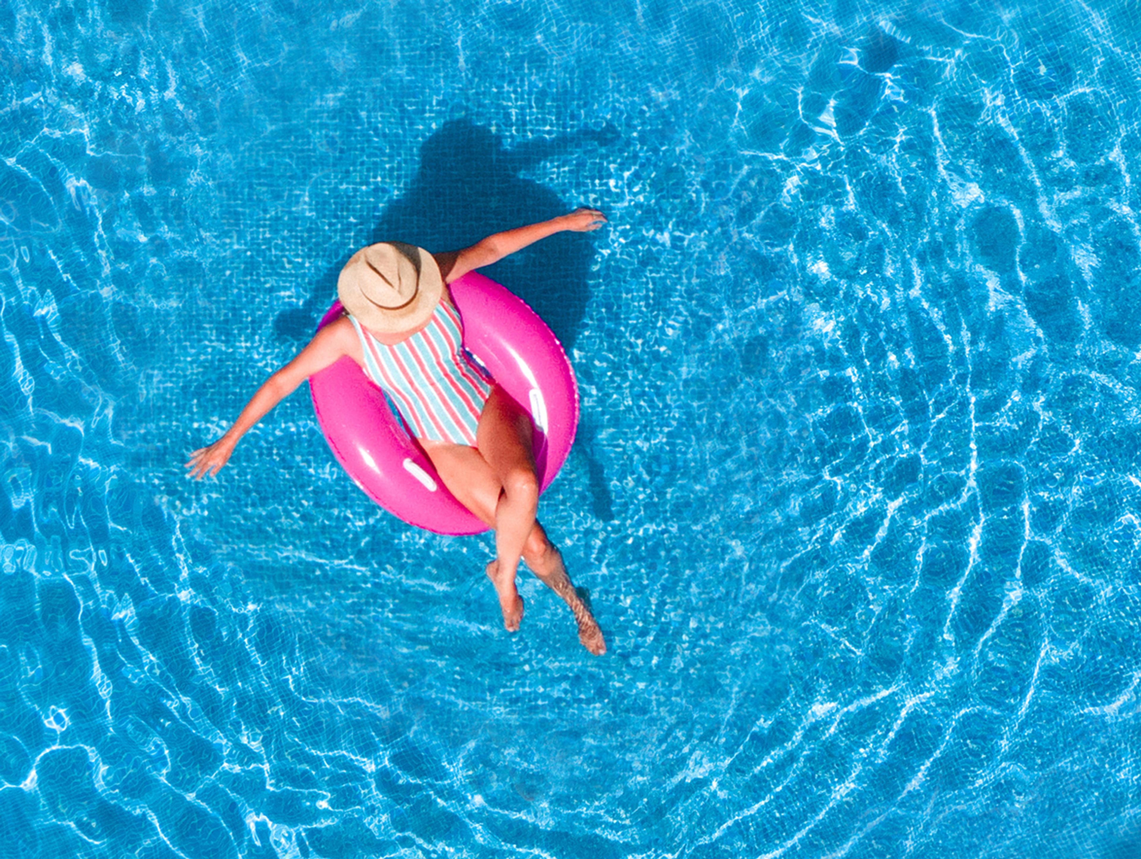 lady floating in the pool on a holiday park.