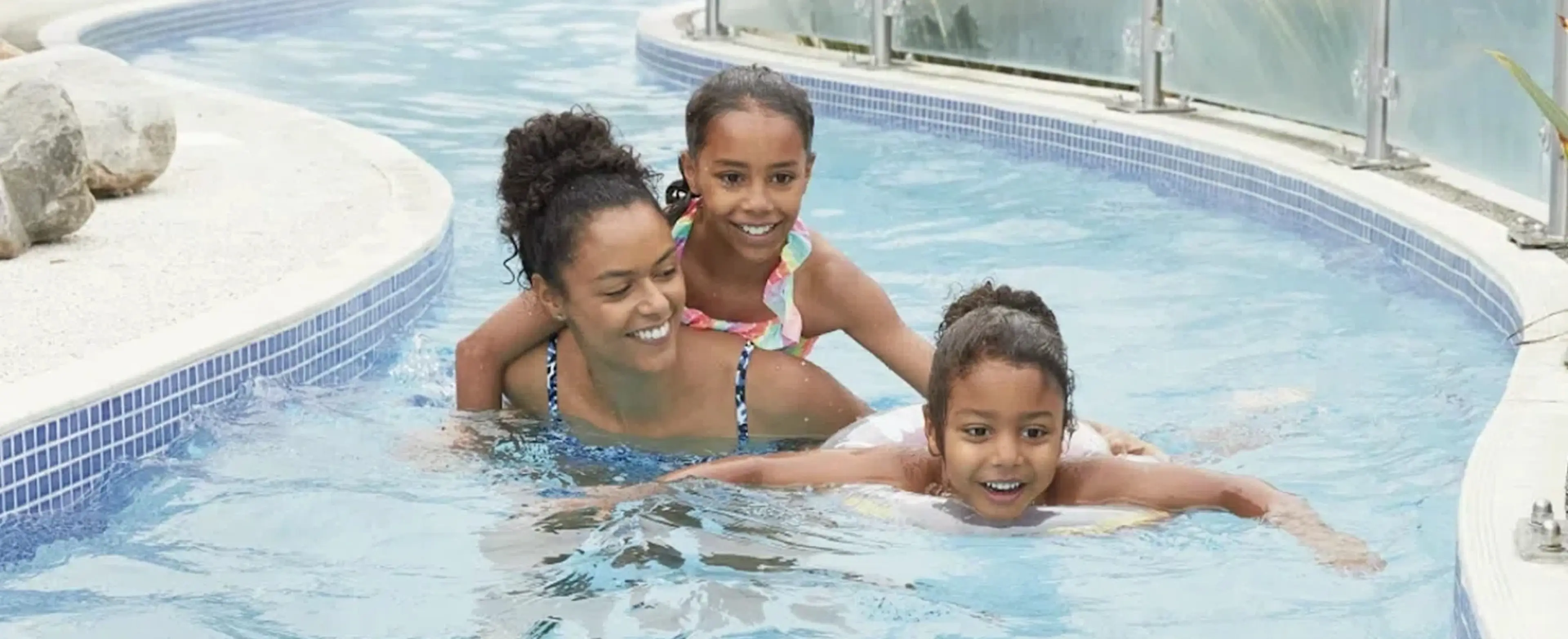 Family in a swimming pool at a Haven Holidays site