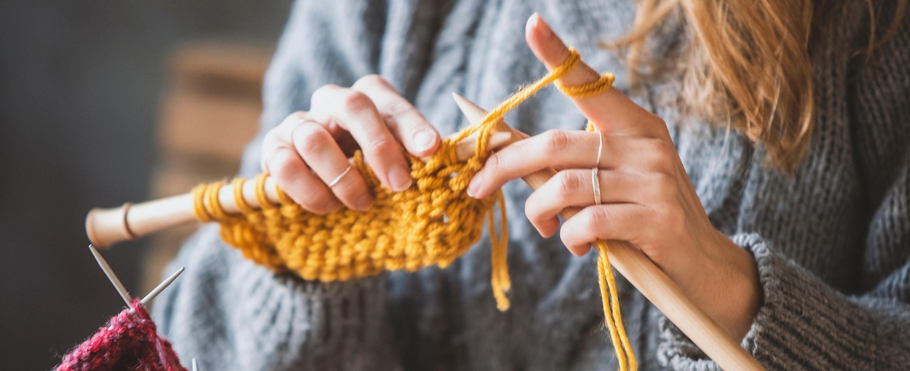 Woman knitting a yellow garment