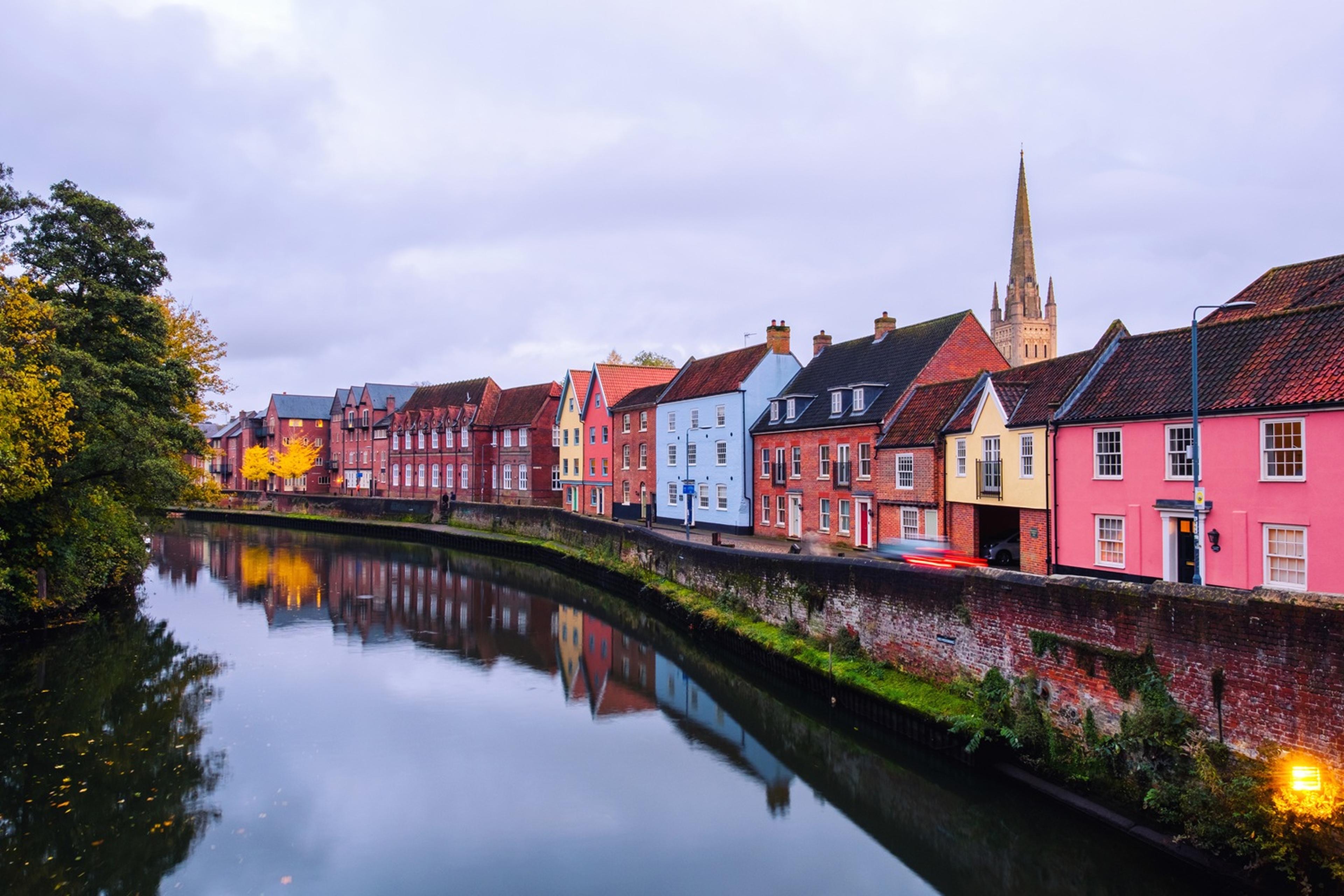 Colourful houses line a riverside in Norwich