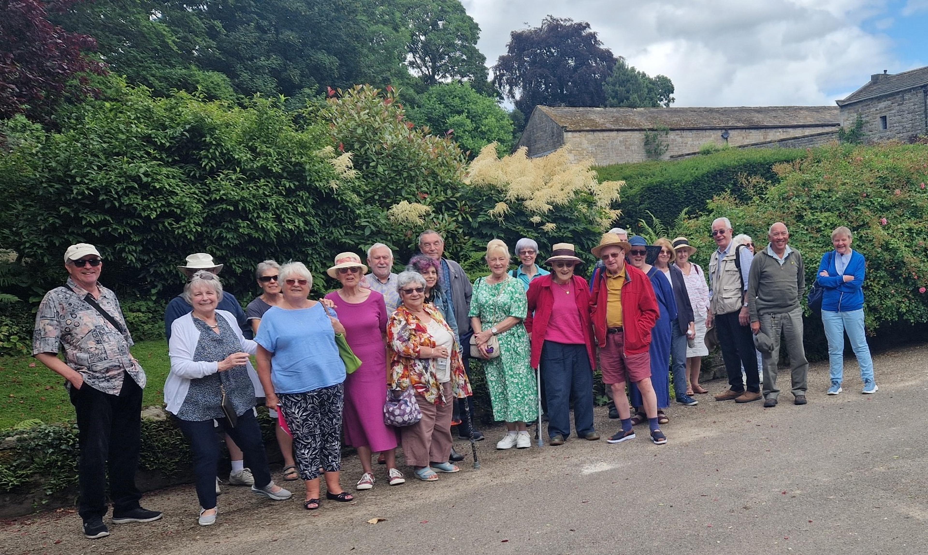 A group of members at a Leeds Group event smiling outdoors