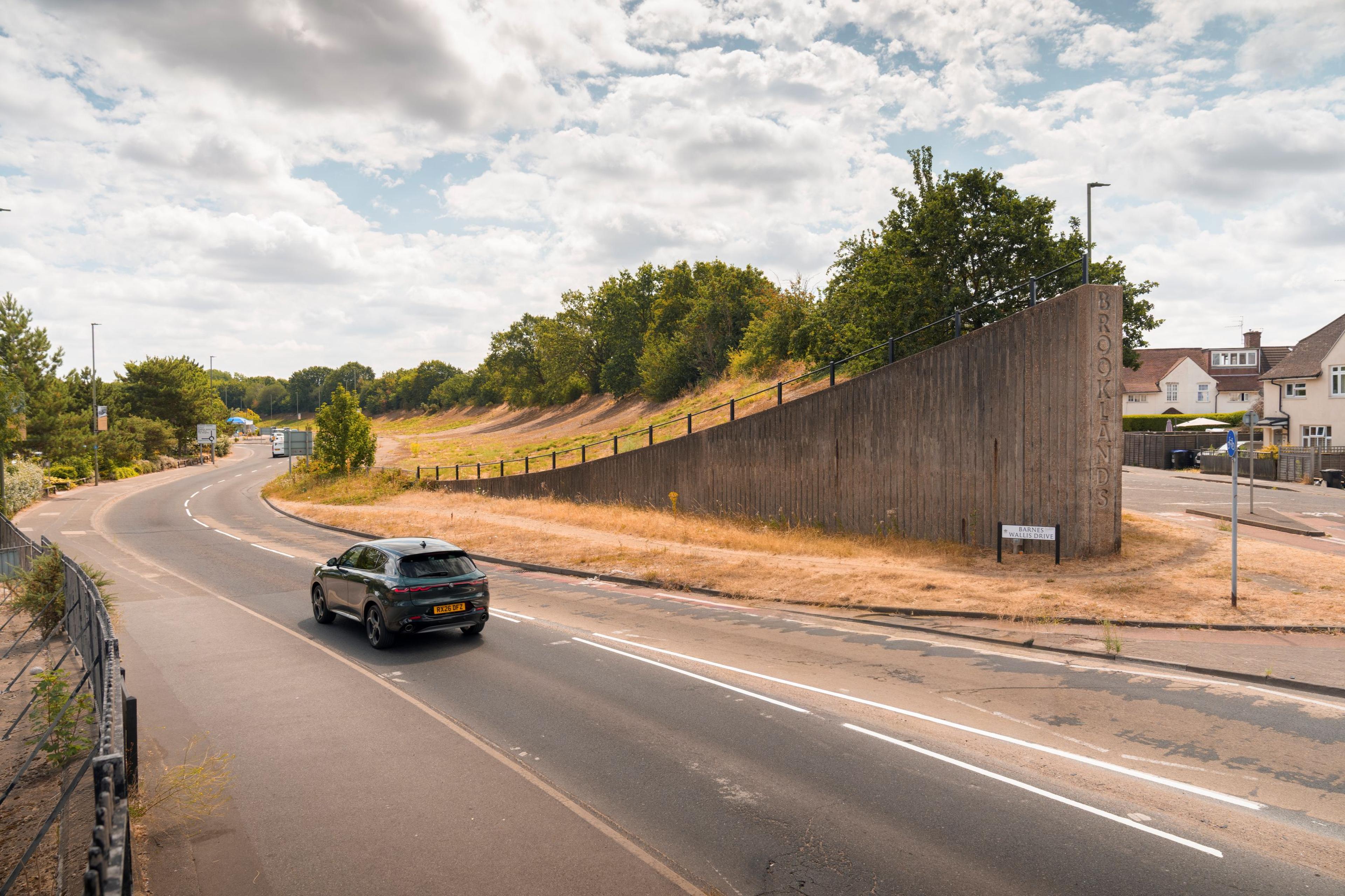 The curved Brooklands racing track with a car driving it