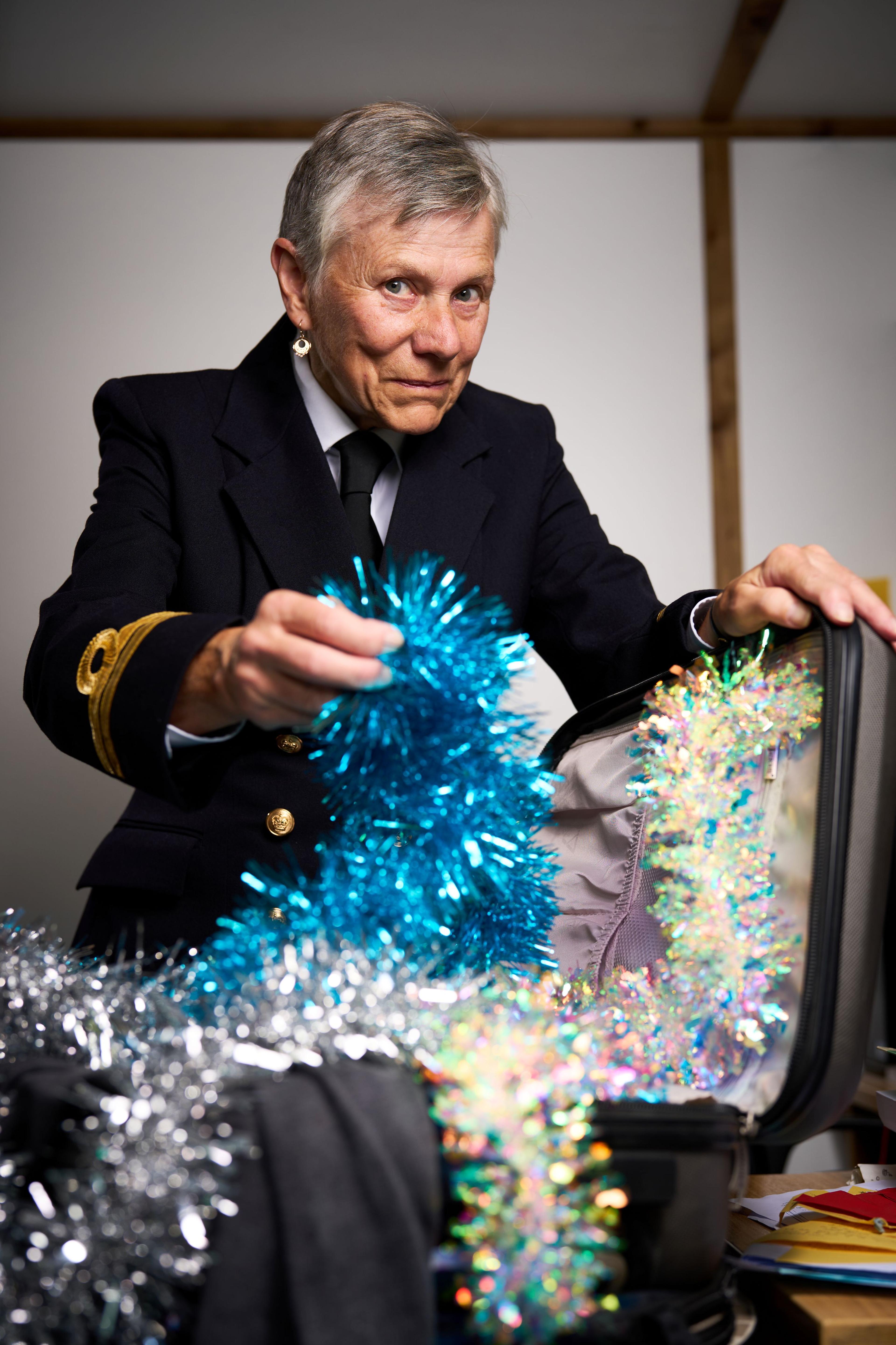 A traffic warden opening a suitcase full of tinsel