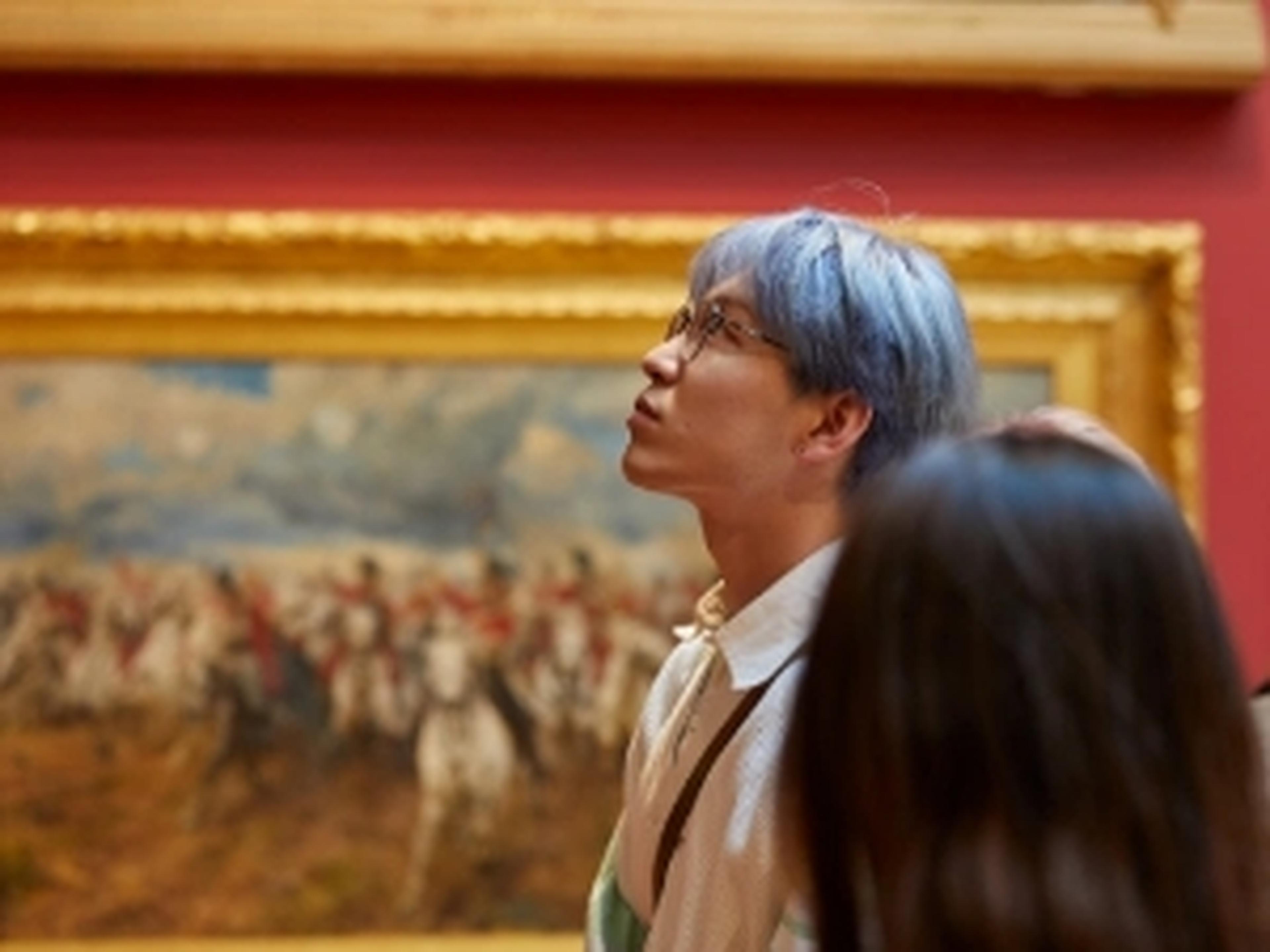 Couple of visitors looking at art