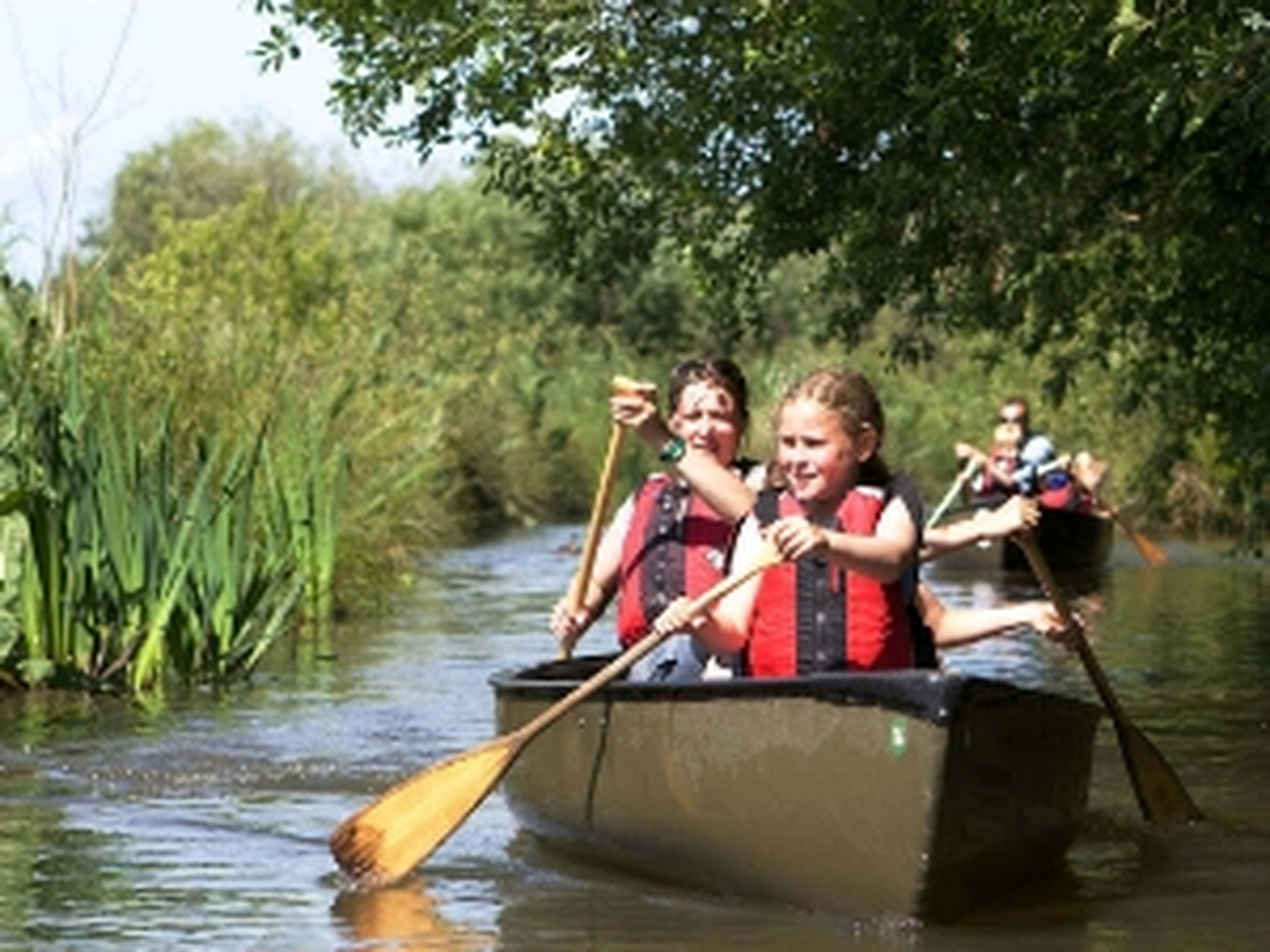 Couple of Boundless members paddling in a canoe