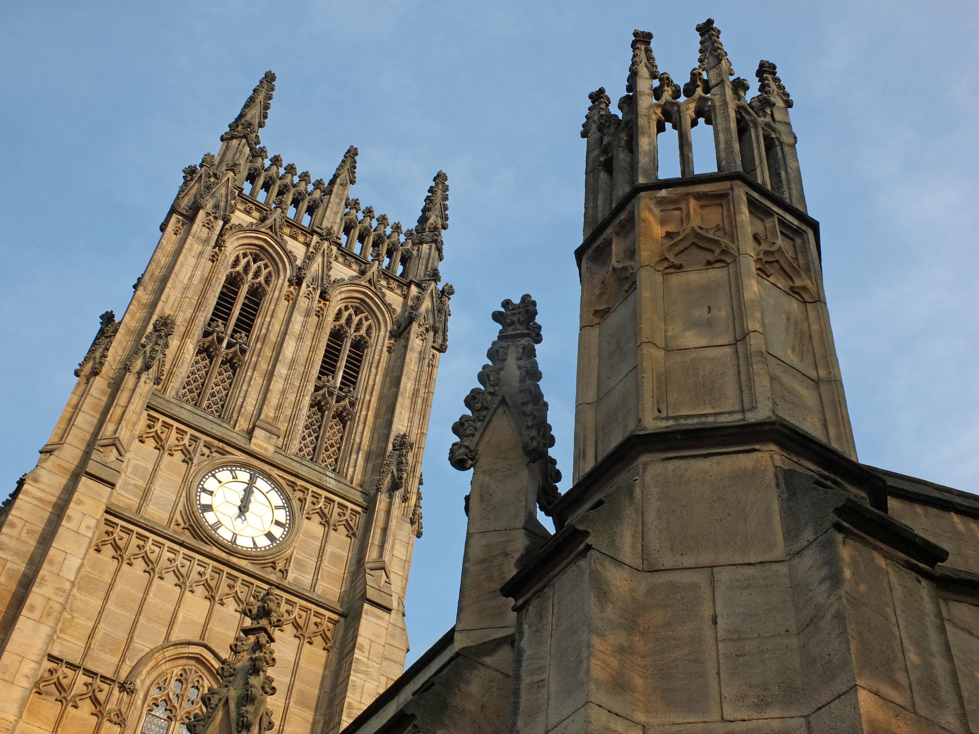 Gothic-style church tower with intricate spires and a clock face