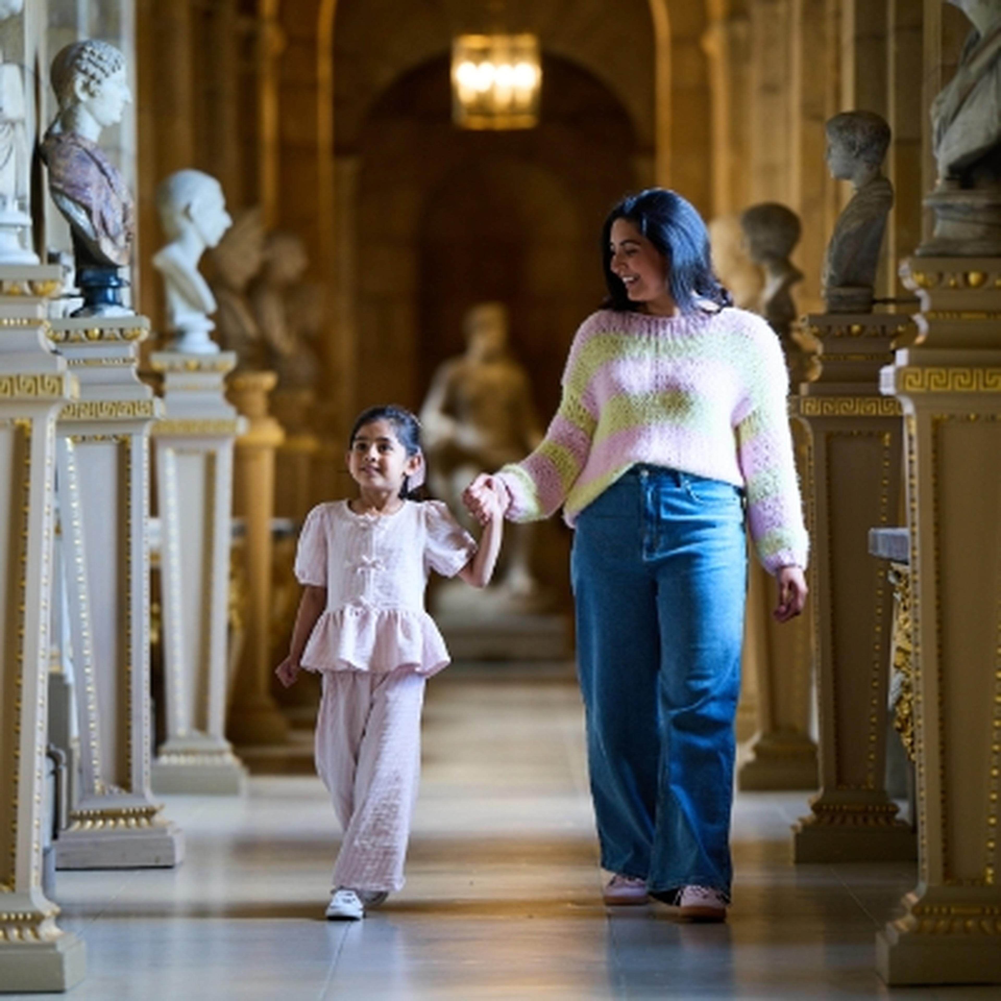 woman and child walking through a grand hall at Castle Howard