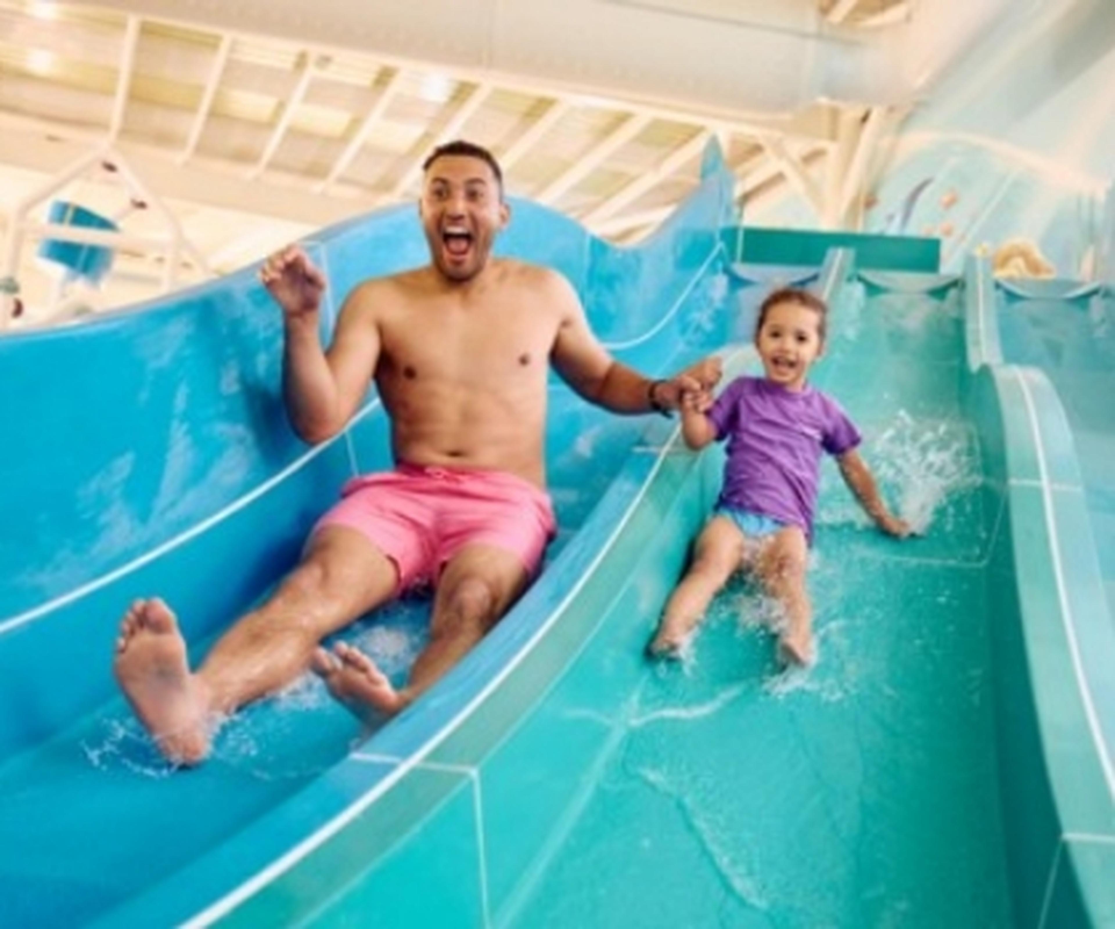Man and child on water slide