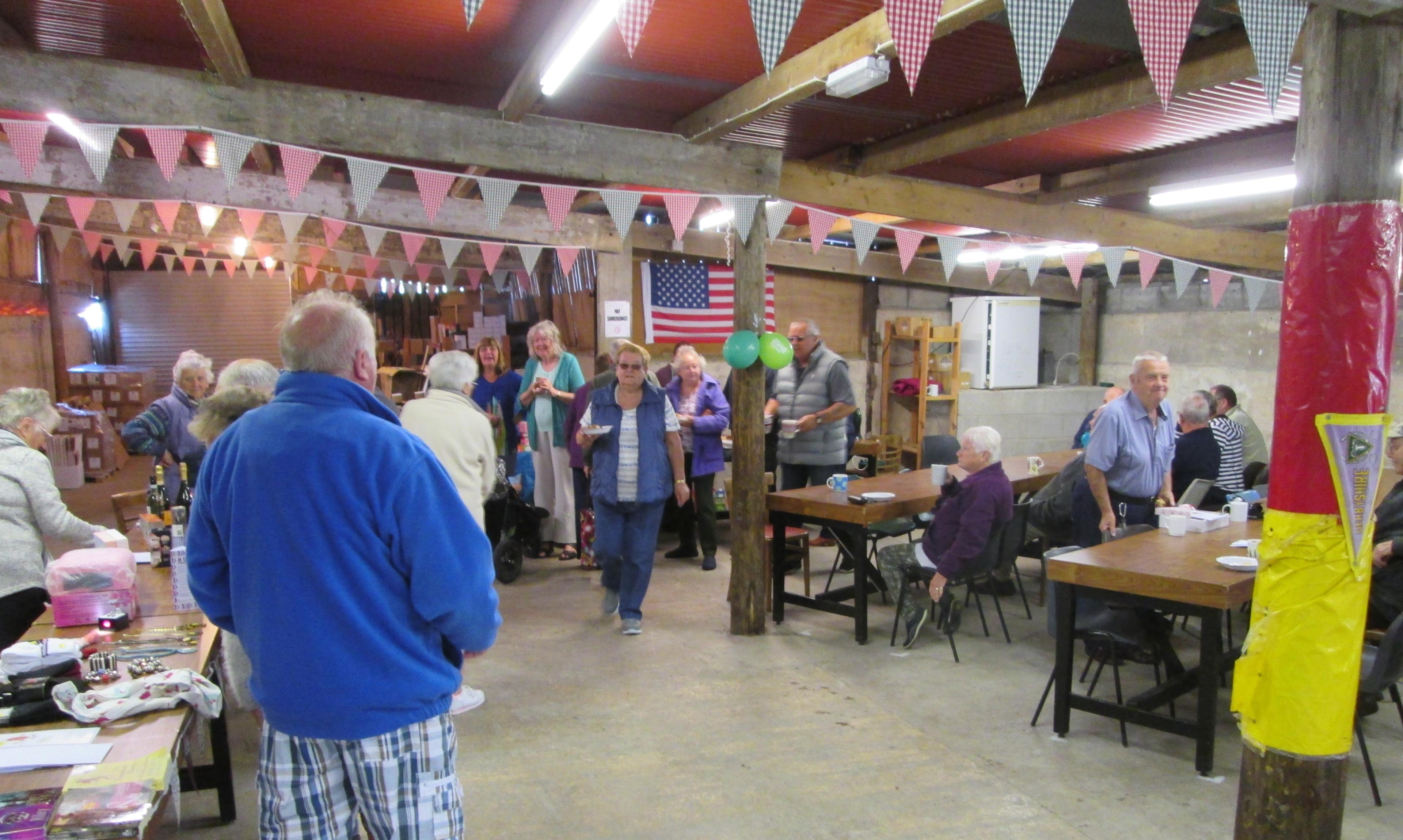 A group of elderly people socializing in a decorated hall