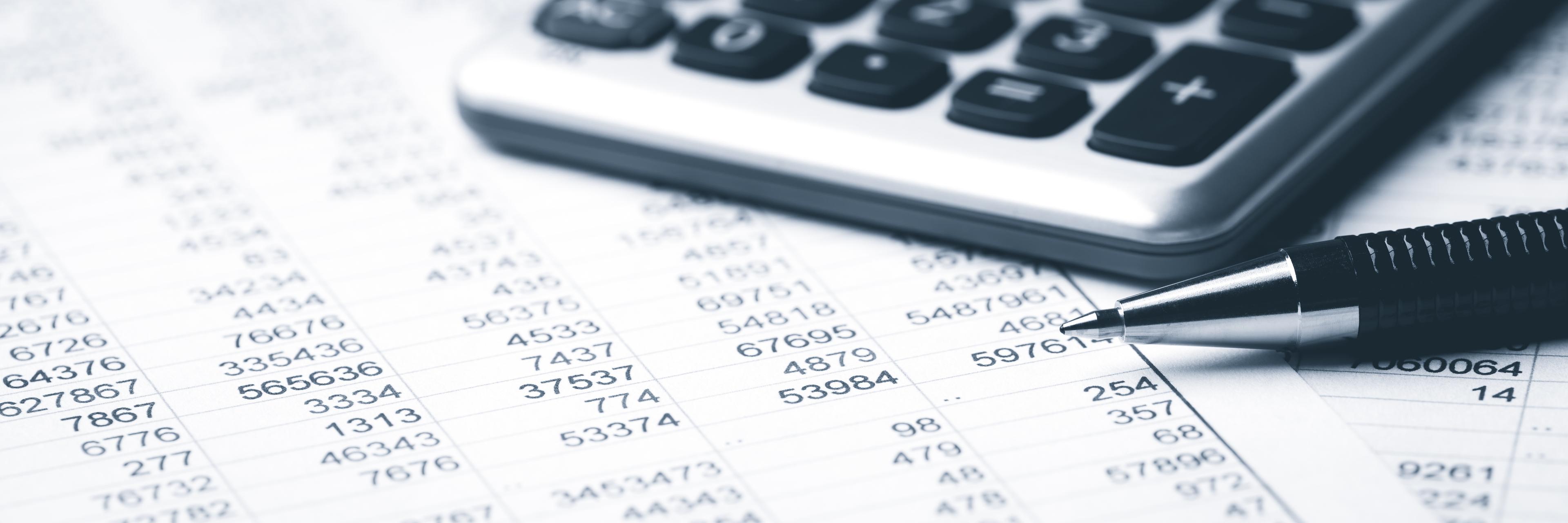 Calculator and pen on sheets of numbers