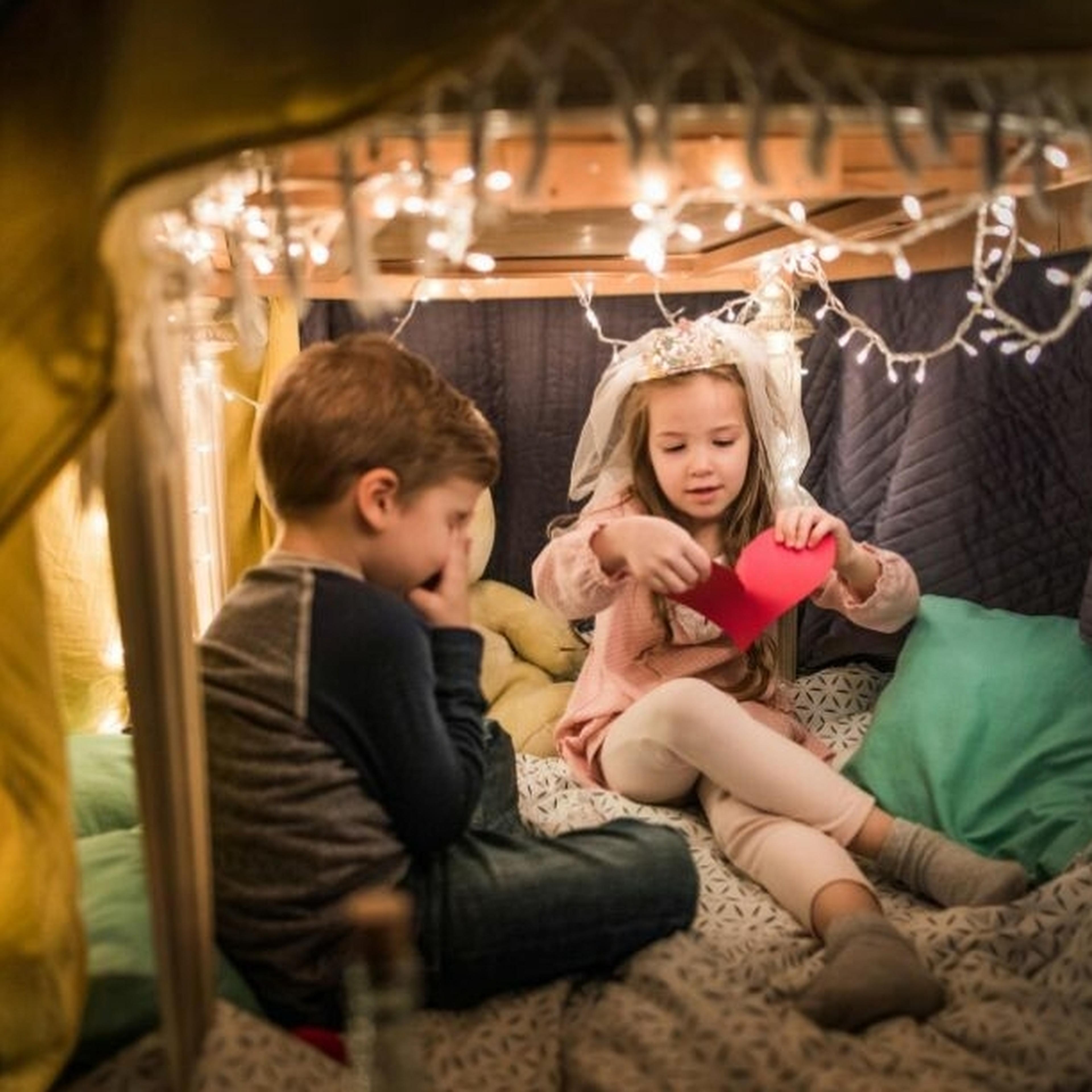 Couple of children sitting in a play tent