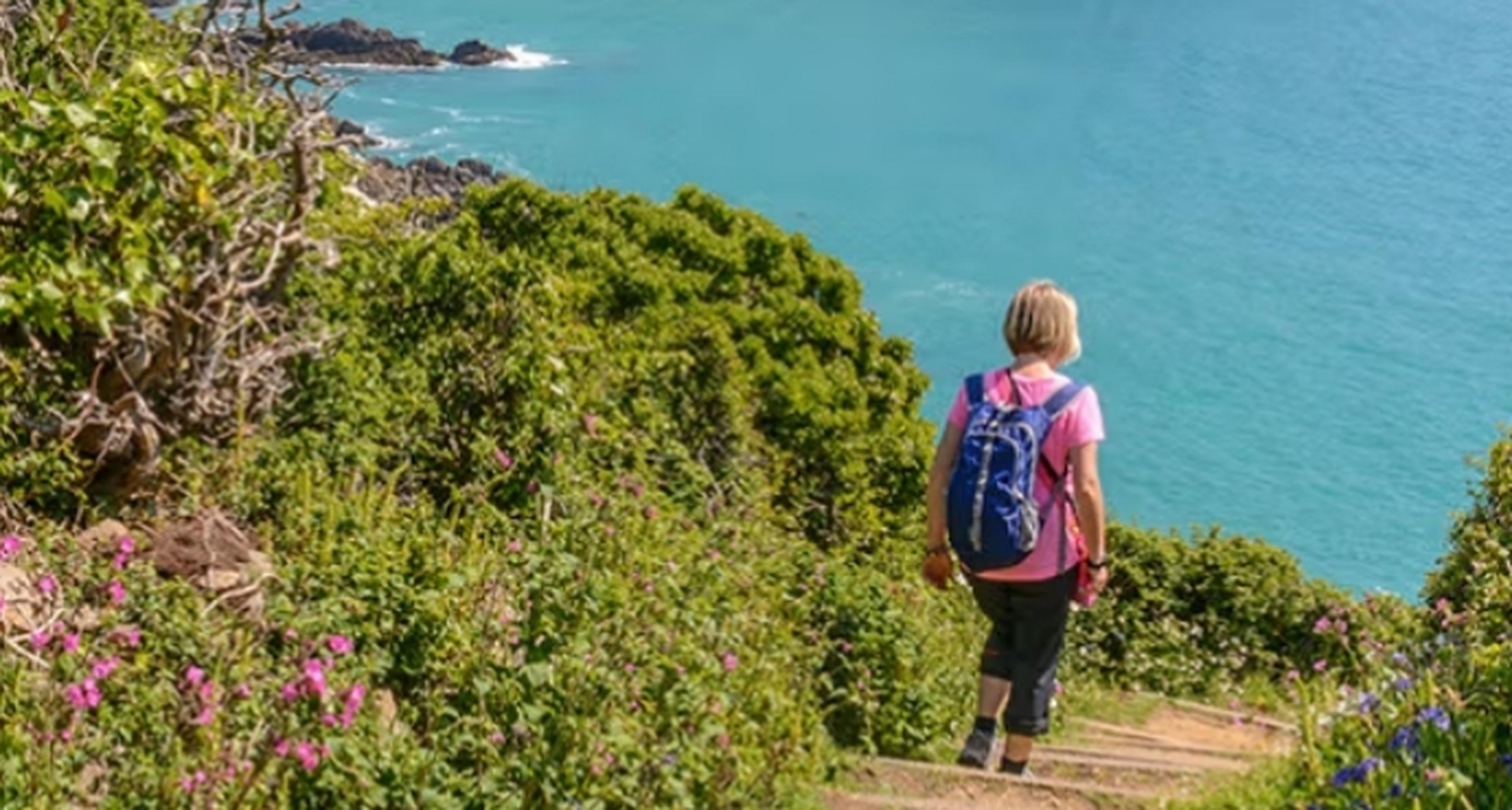 Woman walking on the cliffs in Jersey